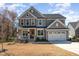Charming two-story home with stone accents, covered porch, two-car garage, and well-manicured lawn at 197 S Clearbook Ct, Angier, NC 27501