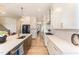 Bright, open kitchen with large island, white cabinetry, stainless appliances, and stylish light fixtures at 197 S Clearbook Ct, Angier, NC 27501