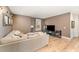 Cozy living room with large sectional sofa, entertainment center, and hardwood floors at 197 S Clearbook Ct, Angier, NC 27501