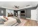 Comfortable main bedroom featuring a fireplace, TV, ceiling fan, and ensuite bathroom at 197 S Clearbook Ct, Angier, NC 27501