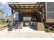 Outdoor kitchen area with stone features and grill for outdoor cooking at 197 S Clearbook Ct, Angier, NC 27501