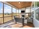 Relaxing screened-in porch featuring wood-burning fireplace and comfortable seating at 197 S Clearbook Ct, Angier, NC 27501