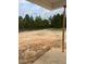 View of the backyard featuring trees and an unfinished area at 200 Dove Rd, Cameron, NC 28326