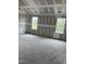 Bedroom featuring unfinished walls and flooring, two large windows overlooking the yard at 200 Dove Rd, Cameron, NC 28326