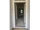 An entryway with an open door, gray walls and unfinished flooring and a view to another room at 200 Dove Rd, Cameron, NC 28326