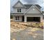 Two-story home featuring a gray exterior, a two-car garage and unfinished landscaping at 200 Dove Rd, Cameron, NC 28326