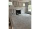 Large living room with a fireplace, bare walls, unfinished flooring and two large windows at 200 Dove Rd, Cameron, NC 28326