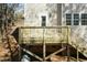 A newly constructed wooden back deck with a door leading to the house and stairs to the yard at 244 Victor Ct, Garner, NC 27529