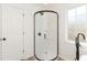 Bathroom featuring a glass enclosed shower with black trim, matte black fixtures, and ample lighting at 244 Victor Ct, Garner, NC 27529