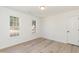 Bedroom with neutral paint, light-colored vinyl flooring, and two windows providing ample natural light at 244 Victor Ct, Garner, NC 27529