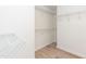 Walk-in closet featuring white wire shelving, neutral paint and modern vinyl flooring at 244 Victor Ct, Garner, NC 27529
