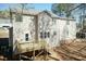 Rear exterior featuring an unfinished wood deck and a spacious yard at 244 Victor Ct, Garner, NC 27529