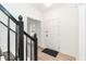 Inviting home foyer featuring clean, white walls, light floors and a contrasting black stair railing at 244 Victor Ct, Garner, NC 27529