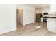 Open kitchen layout featuring stainless steel appliances, white cabinets, and adjacent dining area at 244 Victor Ct, Garner, NC 27529