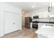Bright kitchen featuring white cabinetry, stainless steel appliances, and neutral countertops with modern lighting at 244 Victor Ct, Garner, NC 27529