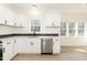 Bright kitchen features white cabinets, stainless steel appliances, and a large window offering natural light at 244 Victor Ct, Garner, NC 27529
