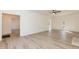 Open-concept living room with hardwood floors, neutral color palette, fireplace, and entryways to other rooms at 244 Victor Ct, Garner, NC 27529
