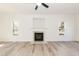 Bright and airy living room with fireplace, ceiling fan and hardwood floors, freshly painted in a neutral color at 244 Victor Ct, Garner, NC 27529