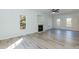Spacious living room with fireplace, light walls, wood floors, and multiple windows providing ample natural light at 244 Victor Ct, Garner, NC 27529