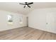Vaulted main bedroom features light-colored flooring, ceiling fan, and two windows at 244 Victor Ct, Garner, NC 27529
