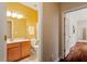 Bathroom with a wooden vanity, large mirror, and neutral walls at 2524 Forest Shadows Ln, Raleigh, NC 27614
