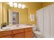 Bright bathroom with a vanity, large mirror, and shower curtain at 2524 Forest Shadows Ln, Raleigh, NC 27614
