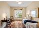 Cozy bedroom with hardwood floors, a ceiling fan and a window offering natural light at 2524 Forest Shadows Ln, Raleigh, NC 27614