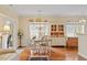 Inviting dining area featuring hardwood floors, a classic chandelier, and abundant natural light at 2524 Forest Shadows Ln, Raleigh, NC 27614