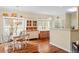 Hardwood floor dining area with large bright windows and a classic hutch, providing ample storage and display space at 2524 Forest Shadows Ln, Raleigh, NC 27614