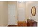 Bright entryway featuring hardwood floors, fresh paint, and decorative mirror at 2524 Forest Shadows Ln, Raleigh, NC 27614