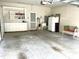 Garage featuring built-in storage cabinets, utility sink, and shelving for organization and convenience at 2524 Forest Shadows Ln, Raleigh, NC 27614