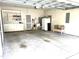 Garage featuring built-in storage cabinets, utility sink, bench and shelving for organization and convenience at 2524 Forest Shadows Ln, Raleigh, NC 27614