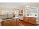 Spacious kitchen showcasing hardwood floors, a double sink, and natural light at 2524 Forest Shadows Ln, Raleigh, NC 27614
