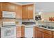Bright kitchen with wooden cabinets, modern appliances, and a stylish sink and countertop at 2524 Forest Shadows Ln, Raleigh, NC 27614