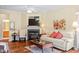 Comfortable living room featuring hardwood floors, a fireplace, and ample lighting at 2524 Forest Shadows Ln, Raleigh, NC 27614