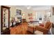 Open living room with hardwood floors, a fireplace, and plenty of natural light at 2524 Forest Shadows Ln, Raleigh, NC 27614