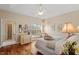 Bright bedroom with tray ceiling, hardwood floors, a fan and a window at 2524 Forest Shadows Ln, Raleigh, NC 27614