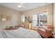 Bright bedroom with tray ceiling, hardwood floors, a fan and a window at 2524 Forest Shadows Ln, Raleigh, NC 27614
