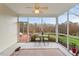 Relaxing screened porch with ceiling fan, table with chairs and nature views at 2524 Forest Shadows Ln, Raleigh, NC 27614