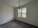 Bedroom with plush carpeting, neutral walls and a view to the outdoors through the large window at 274 Longbow Dr, Middlesex, NC 27557
