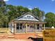 New home under construction with a covered porch and lumber deck showcasing the building process at 274 Longbow Dr, Middlesex, NC 27557