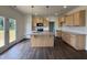 Open kitchen featuring an island, stainless steel appliances, and hardwood floors at 274 Longbow Dr, Middlesex, NC 27557