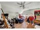 Unfinished attic with sloped ceilings, wood flooring, storage, and a ceiling fan at 290 Collie Rd, Castalia, NC 27816