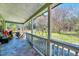Back porch overlooking a yard with lush trees and a swing set at 290 Collie Rd, Castalia, NC 27816