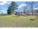 The fenced backyard features a large grassy area and mature trees providing ample shade at 290 Collie Rd, Castalia, NC 27816