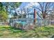 Charming home featuring blue siding, brick chimney, mature trees, a fenced yard, and a lush lawn at 290 Collie Rd, Castalia, NC 27816