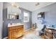 Bathroom with a wooden sink cabinet, mirror, toilet, and shelves with natural light at 290 Collie Rd, Castalia, NC 27816