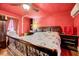 Cozy bedroom with dark wooden furniture, a ceiling fan, and a comfy queen-size bed at 290 Collie Rd, Castalia, NC 27816