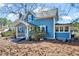 Charming two-story home featuring a covered porch and a well-maintained yard with mature trees at 290 Collie Rd, Castalia, NC 27816