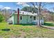 Quaint single-story home with light green siding, white trim, and a metal roof at 290 Collie Rd, Castalia, NC 27816